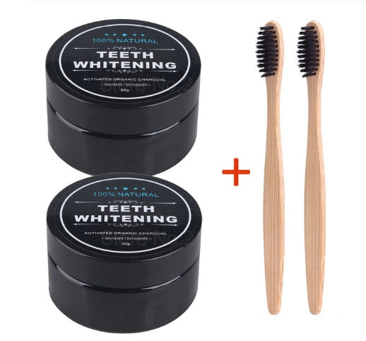 Two charcoal teeth whitening powder jars with two wooden toothbrushes