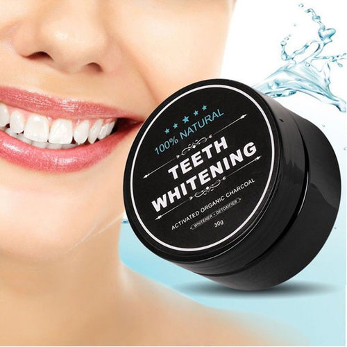Charcoal teeth whitening powder jar with label, next to water splash and teeth