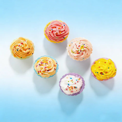 Assorted cupcake-shaped bath bombs with swirled tops in pastel orange, pink, blue, and purple