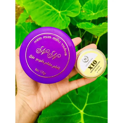 Purple body lotion jar and small cream jar, both in hand with green leaves backdrop