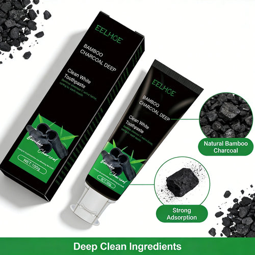 Bamboo charcoal toothpaste tube beside boxed carton, black-and-green with charcoal pieces