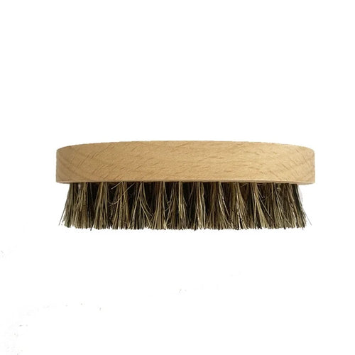 Oval wooden beard brush with dense boar bristles, flat top view