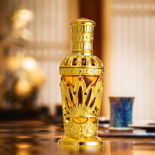 Gold Arabian perfume bottle with ornate crown cap and decorative blue accents